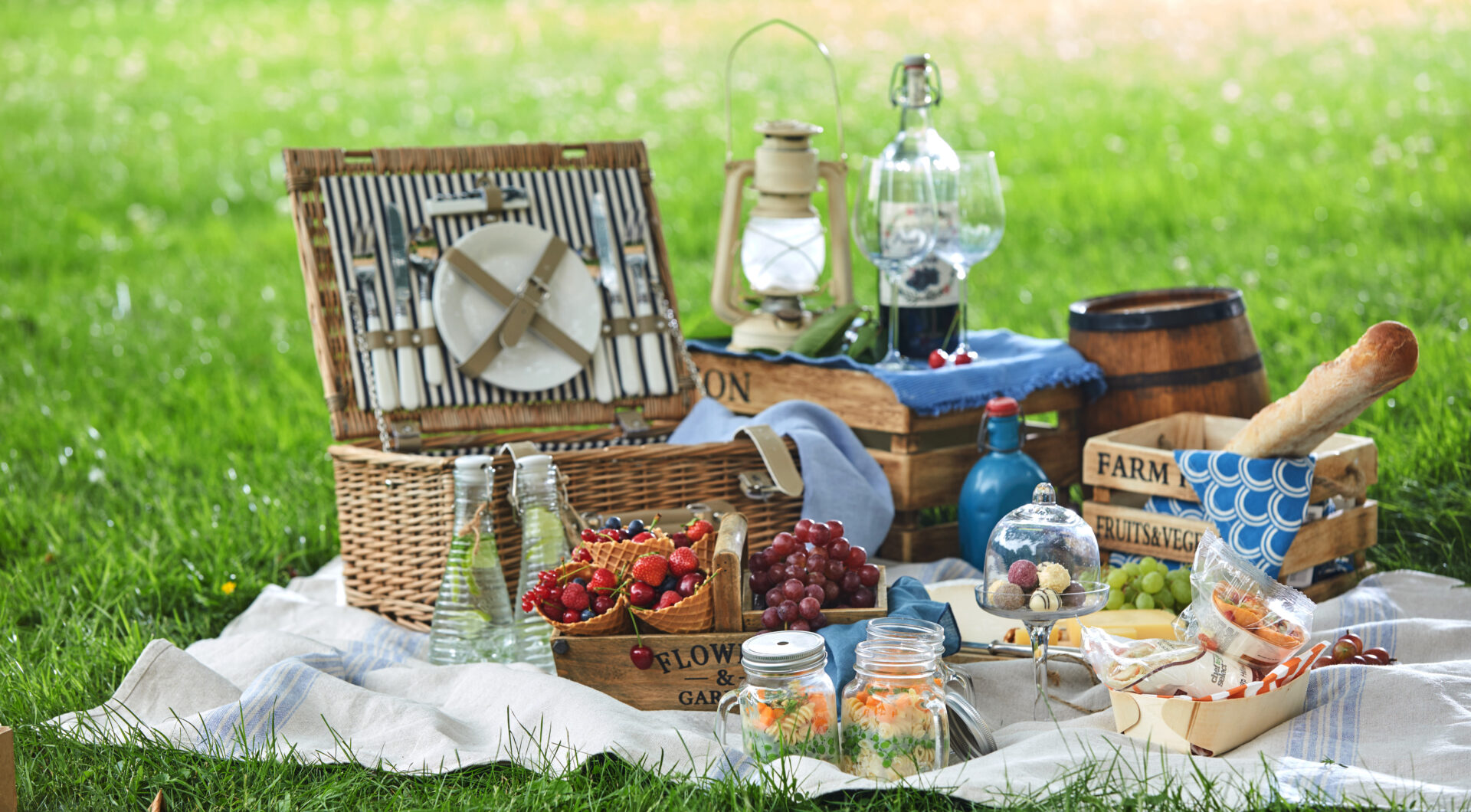 Vintage picnic hamper with lunch in a park