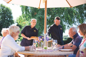 photo of Laura and Nathan serving guests at English Cottage Vacation