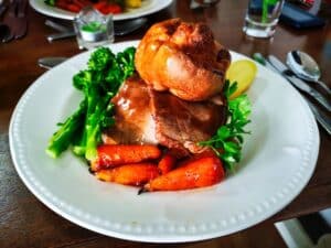 Photo of a traditional English meal of roast beef and Yorkshire pudding