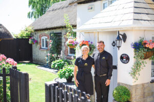 ECV Nathan & Laura in front of Well Cottage