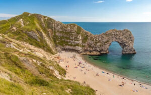 ecv Durdle Door Jurassic Coast Dorset beach people sunbathing and swimming