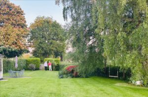 Guests enjoying a stroll around the Well Cottage gardens