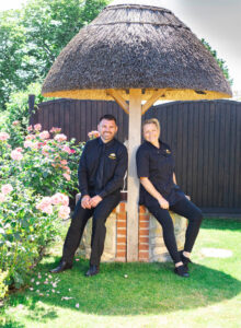 Laura and Nathan beside the working well at Well Cottage