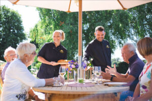 Laura and Nathan serving guests outdoors