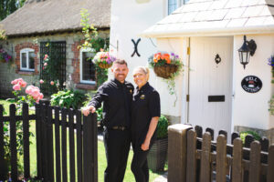 Nathan and Laura in front of Well Cottage